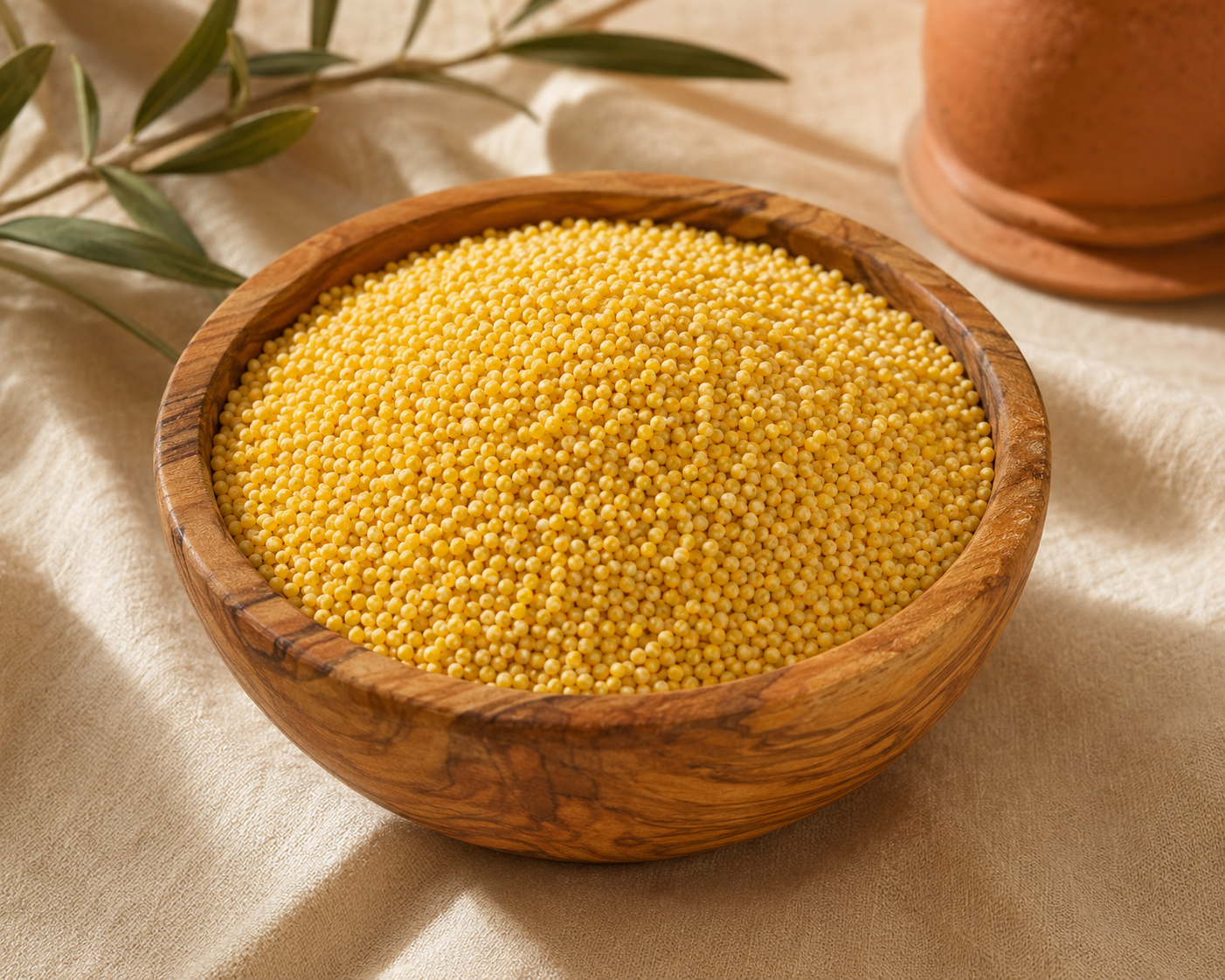 Golden millet grains in a wooden bowl
