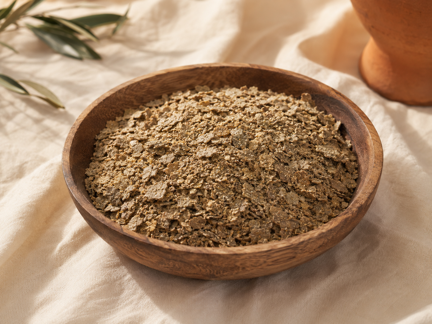 Sunflower meal flakes in a wooden bowl